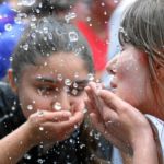 BERN, 12JUN16 - Die Tropfen vom Himmel reichten einigen Laeuferinnen nicht, sich abzukuehlen. Feuerwerschlaeuche auf der Strecke und im Ziel spendeten anlaesslich des 30. Schweizer Frauenlauf in Bern am 12. Juni 2016 kuehlendes Nass.Impression of the 30th Swiss Women's Run in Bern, Switzerland, June 12, 2016. With more than 16,000 participants, the Swiss Women's Run is the largest women's sports event in Switzerland.swiss-image.ch/Photo Andy Mettler
